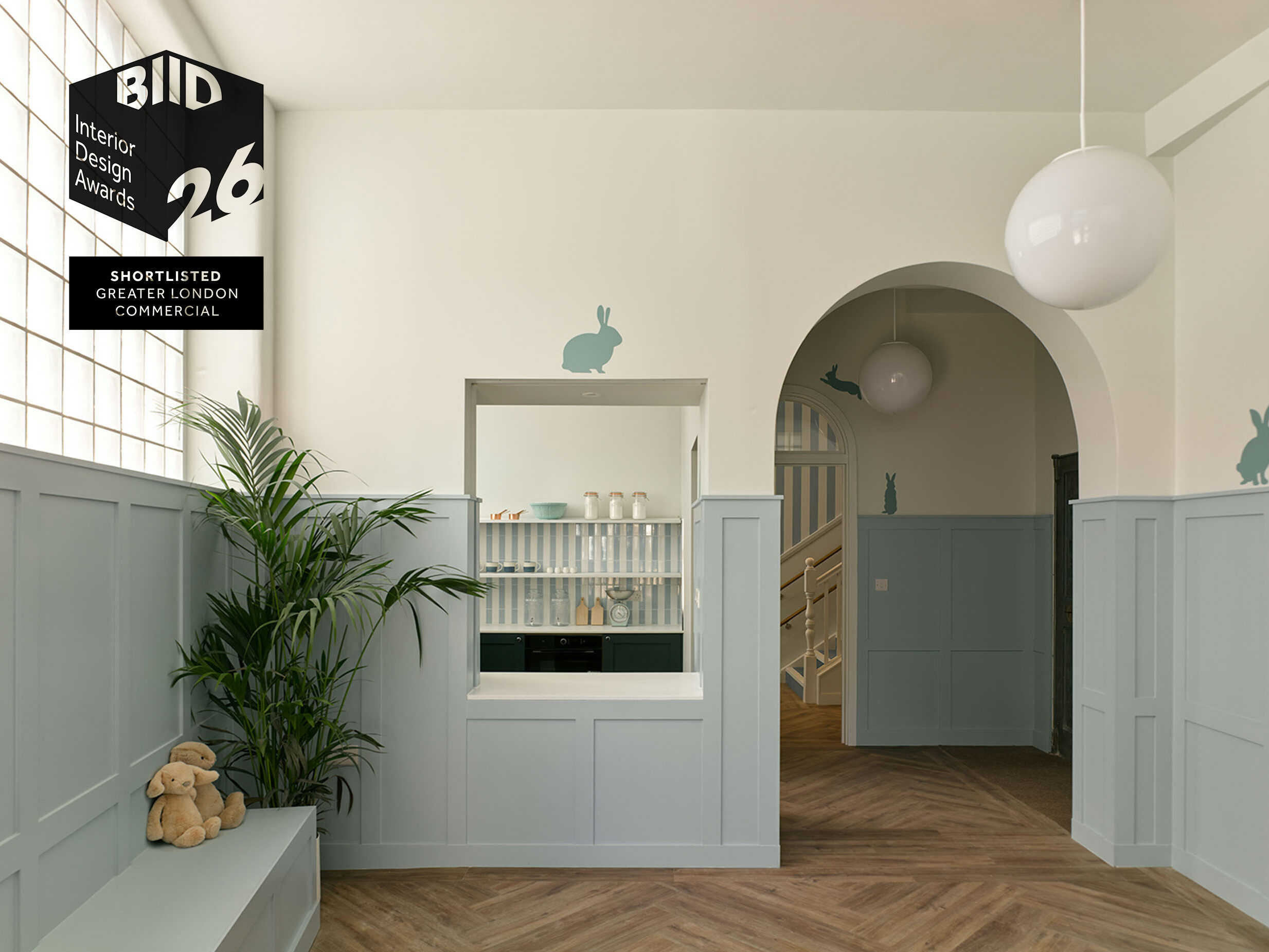 interior photographs of a nursery with glass blocks , archways and stripy wallpaper